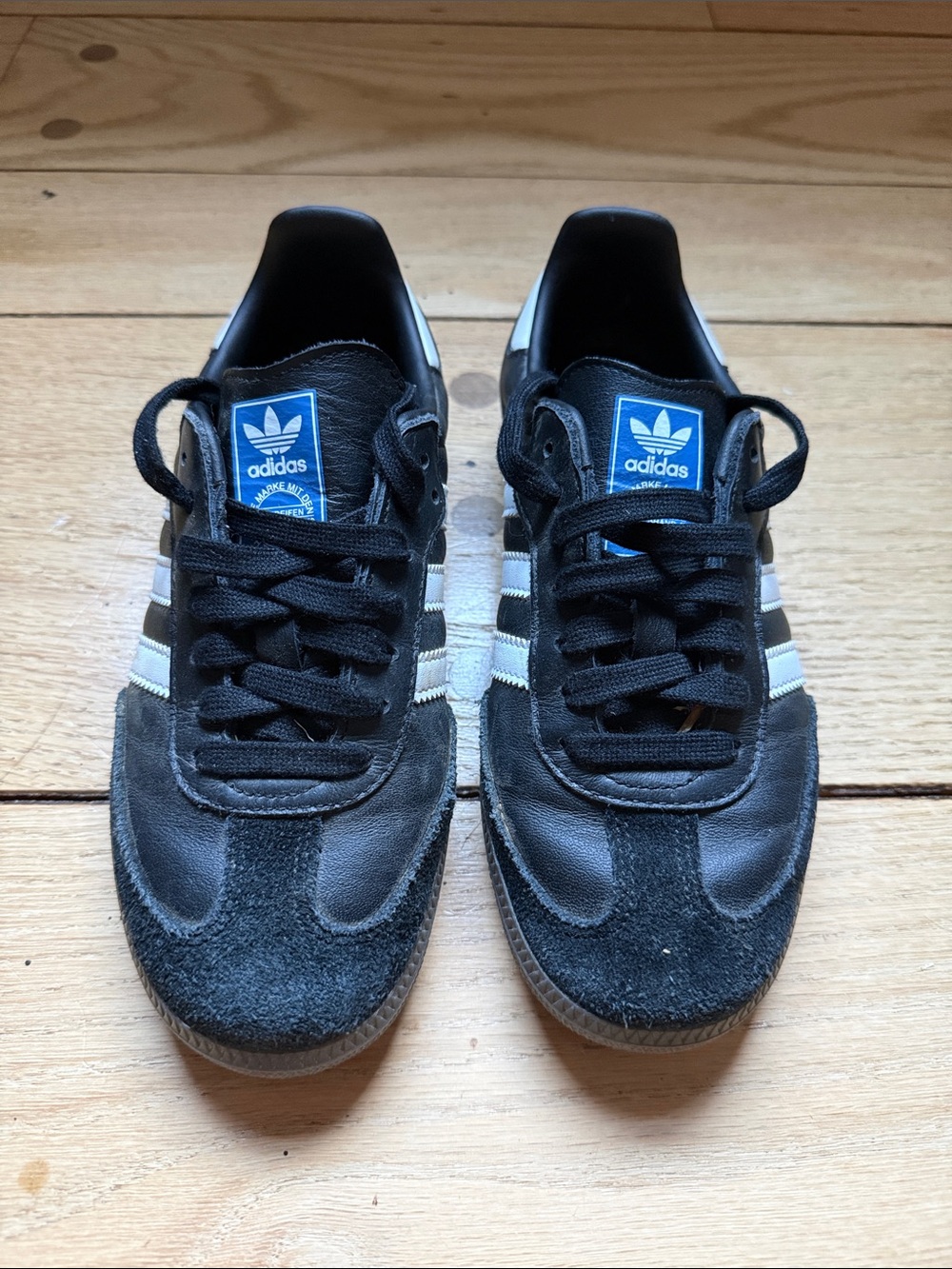 adidas men’s Samba Sneakers in Black and White with Blue Tongue Label